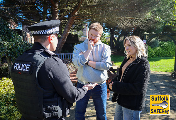 Two police officers in uniform walk outdoors